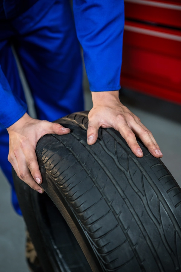 mechanic pushing tyre